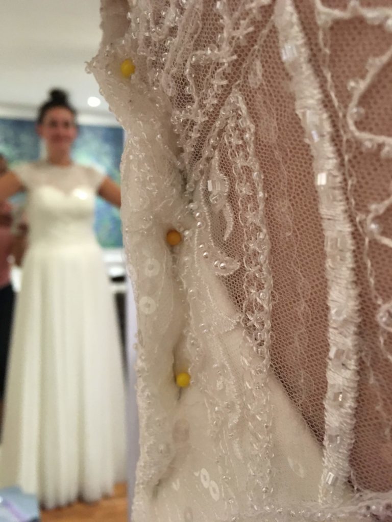 wedding dress alterations zoom in with bride in the mirror